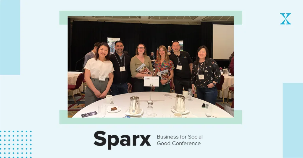 A graphic reading Sparx Business for Social Good Conference framing a photo of six people posed together at a round conference table